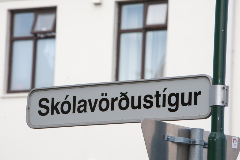 Street sign and windows of a house